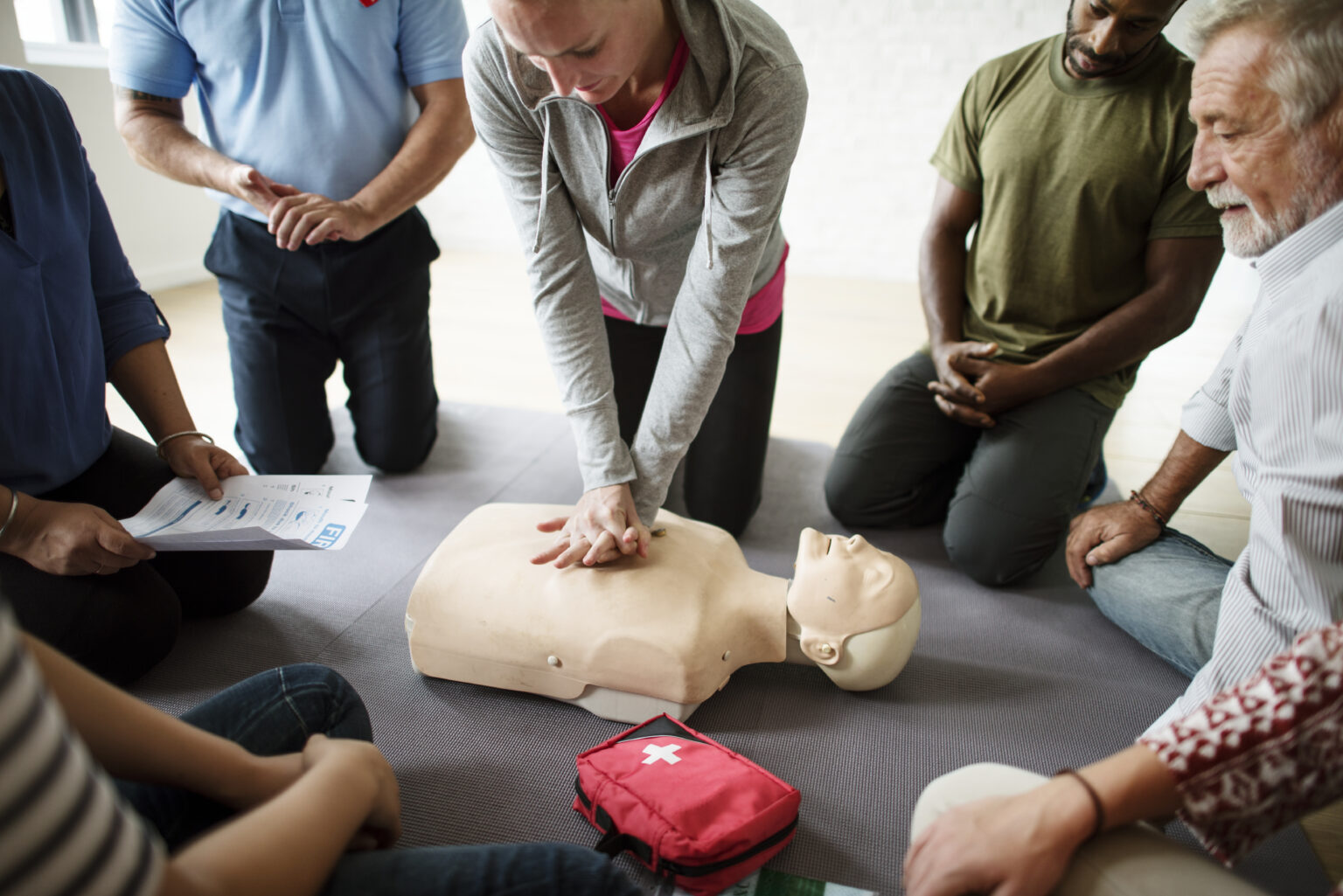 Group practicing chest compressions during a CPR class